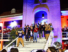 Photo of homecoming with Wilbur and Wilma Wildcat. Links to Gifts of Real Estate