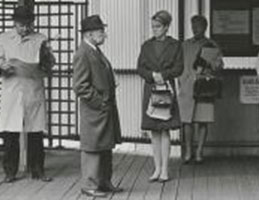 Photo of people at a train station. Links to Arthur J. Bell story